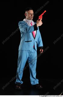 062018 01  MIKAEL STANDING POSE WITH RED PISTOL